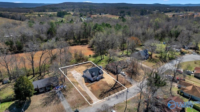 bird's eye view with a wooded view
