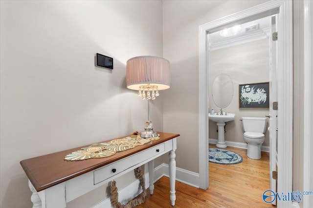 hall with baseboards and wood finished floors