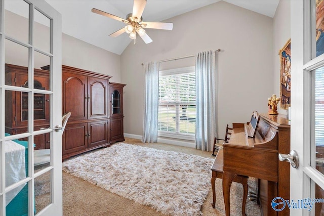 home office featuring a ceiling fan, vaulted ceiling, and carpet flooring