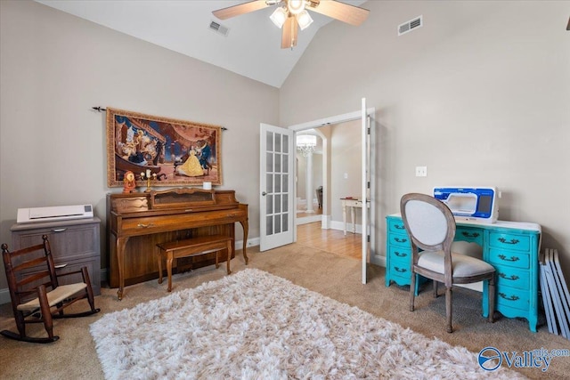 carpeted office with a ceiling fan, high vaulted ceiling, visible vents, and baseboards