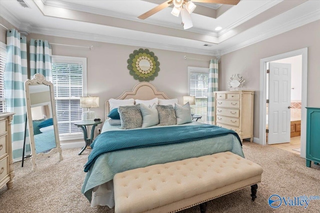 bedroom featuring multiple windows, ornamental molding, and a raised ceiling