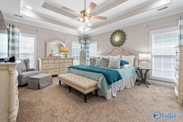 carpeted bedroom featuring crown molding, multiple windows, and visible vents