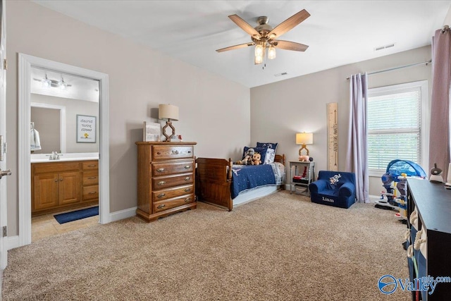 bedroom with visible vents, light carpet, and a sink