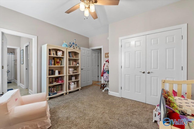 bedroom featuring baseboards, a ceiling fan, a closet, and light colored carpet