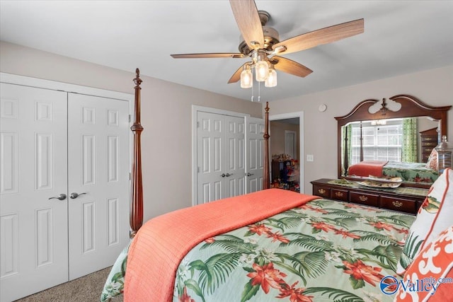 bedroom featuring carpet flooring, ceiling fan, and two closets