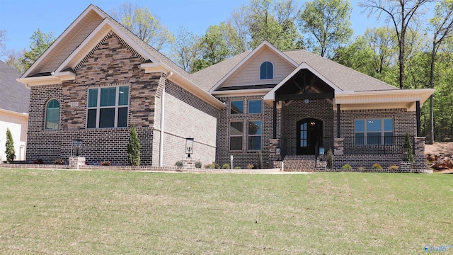 view of front of property with brick siding, a front lawn, and a shingled roof