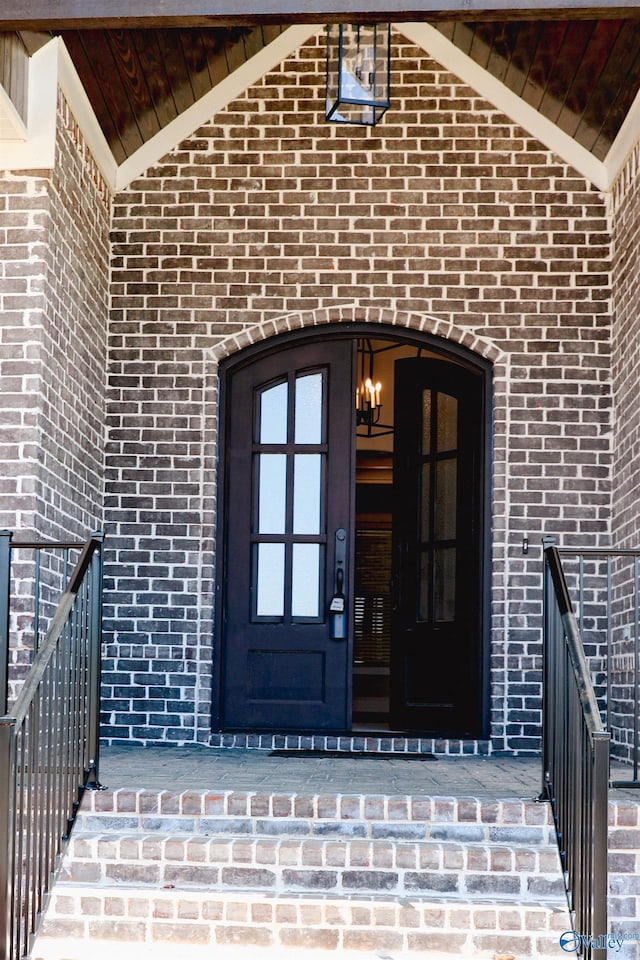 entrance to property with brick siding and covered porch