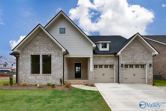 craftsman-style house featuring central AC, a garage, and a front yard