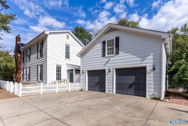 904 Line St NE, Decatur, AL 35601 - traditional-style home featuring fence, a chimney, concrete driveway, and a garage