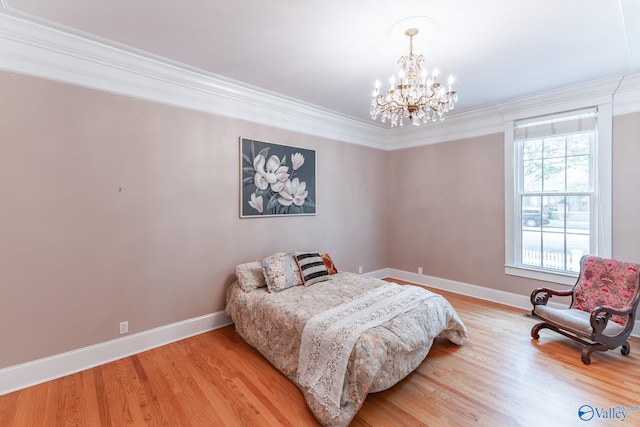 bedroom featuring crown molding, a chandelier, and light wood-type flooring