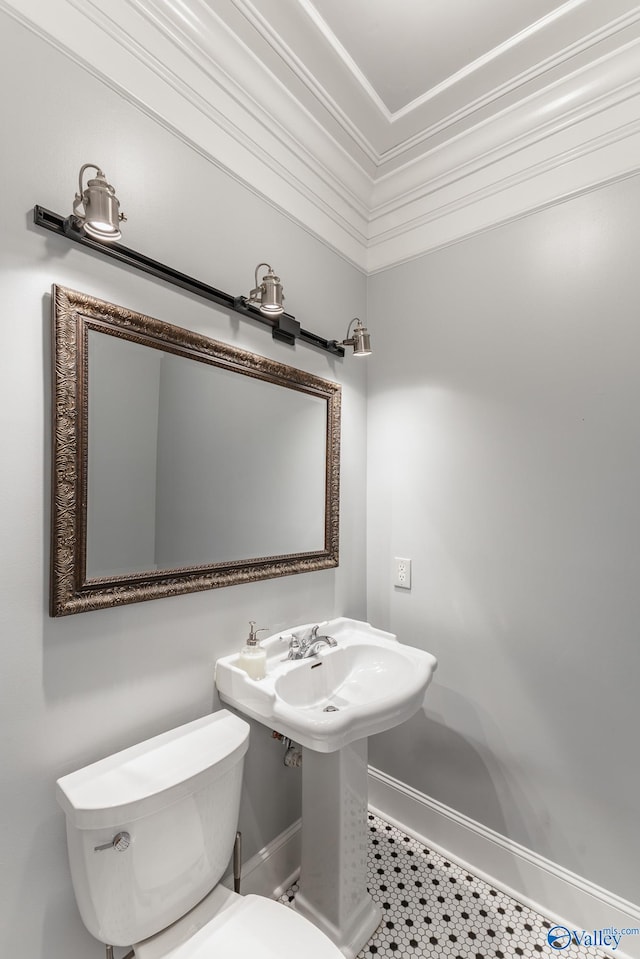 bathroom with toilet and crown molding