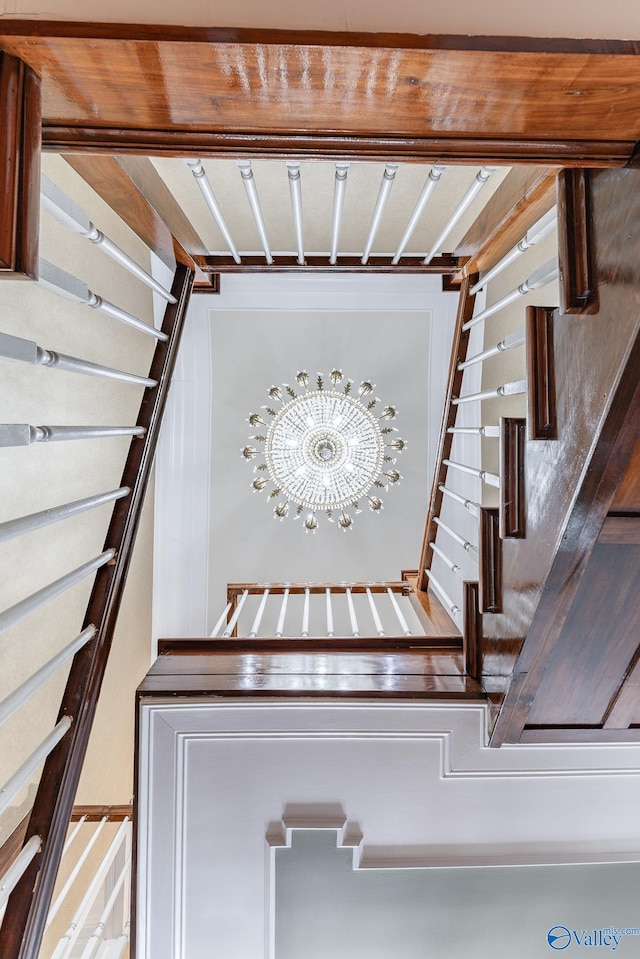 stairs with a chandelier