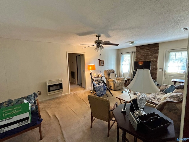 carpeted living room featuring a textured ceiling, heating unit, and a wealth of natural light