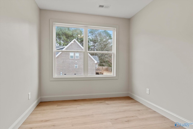 spare room featuring light hardwood / wood-style floors