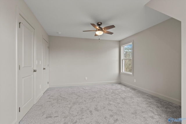 unfurnished bedroom with ceiling fan and carpet