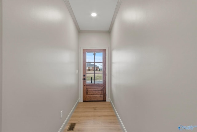 doorway to outside with crown molding and light wood-type flooring