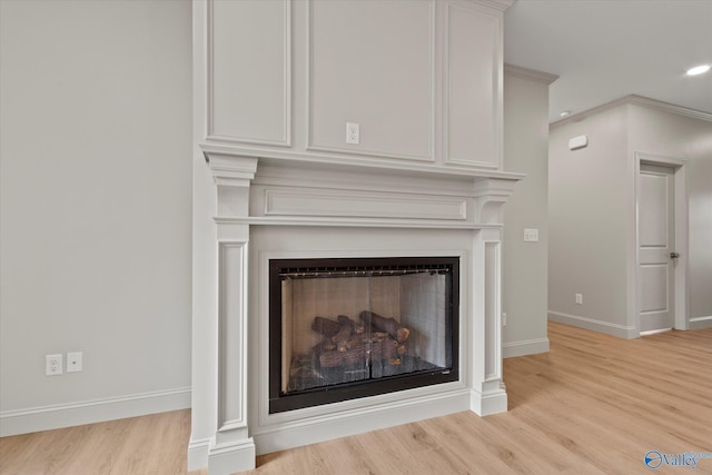 details with wood-type flooring and a large fireplace