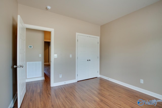 unfurnished bedroom with wood-type flooring