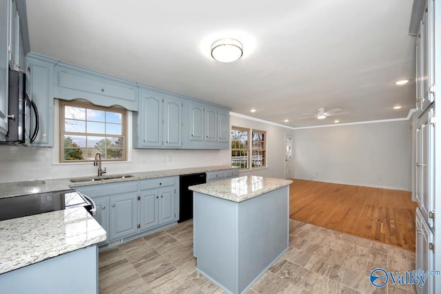 kitchen with sink, crown molding, light stone counters, black appliances, and a kitchen island