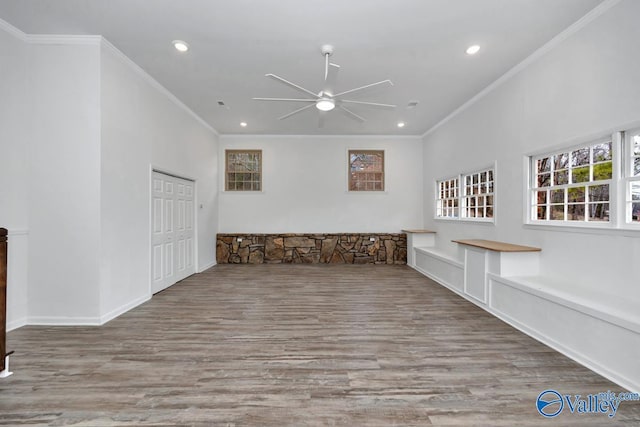 unfurnished room featuring ornamental molding, ceiling fan, and light wood-type flooring