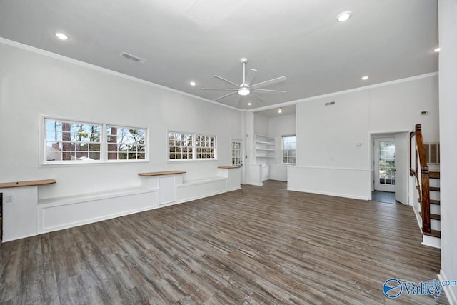 unfurnished living room featuring crown molding, dark wood-type flooring, and ceiling fan