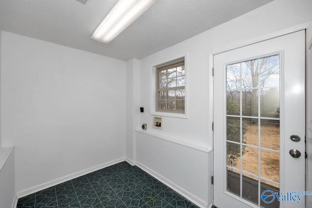 laundry area featuring hookup for a washing machine, a textured ceiling, and electric dryer hookup