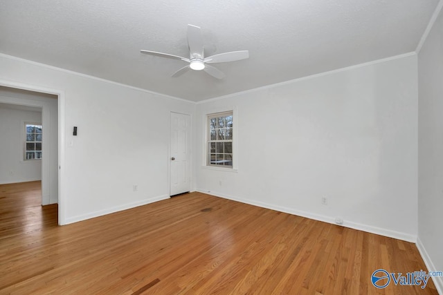 empty room with ceiling fan, ornamental molding, and hardwood / wood-style floors