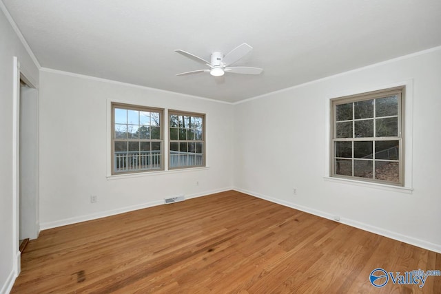 spare room with wood-type flooring, ceiling fan, and crown molding