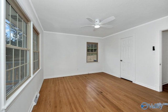 unfurnished bedroom featuring wood-type flooring, ceiling fan, and crown molding