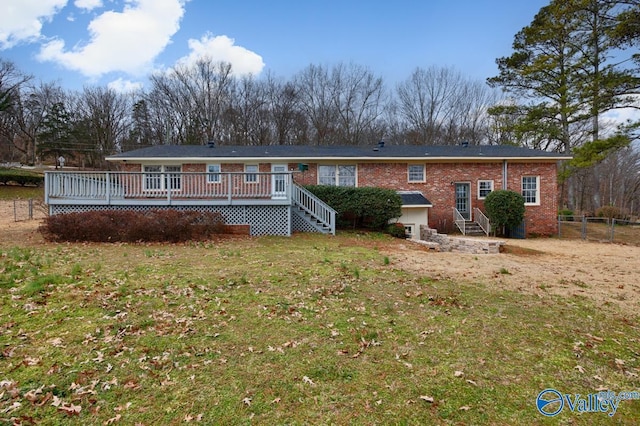 view of front facade featuring a wooden deck and a front yard