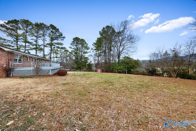 view of yard featuring a wooden deck