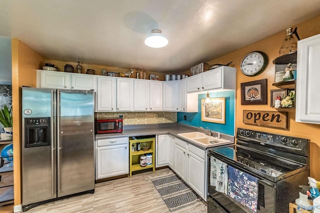2122 Fernbrook Dr NE, Huntsville, AL 35811 - kitchen featuring stainless steel fridge with ice dispenser, black electric range oven, white cabinetry, and light wood-style floors