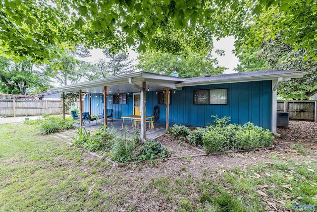 2122 Fernbrook Dr NE, Huntsville, AL 35811 - ranch-style house with board and batten siding, a fenced backyard, and a patio area