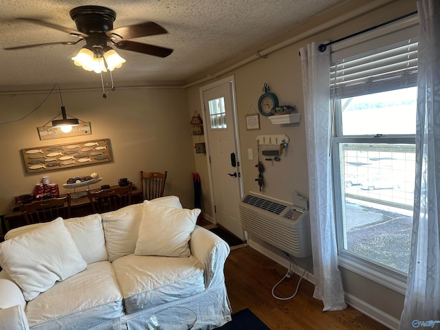 living room featuring ceiling fan, hardwood / wood-style flooring, a textured ceiling, and heating unit