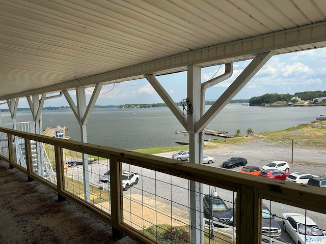 unfurnished sunroom featuring a water view