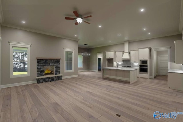 kitchen with built in microwave, open floor plan, oven, and a sink