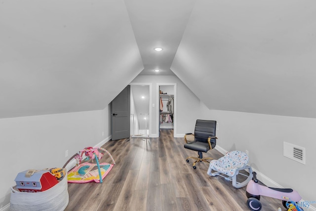 recreation room featuring lofted ceiling and hardwood / wood-style flooring