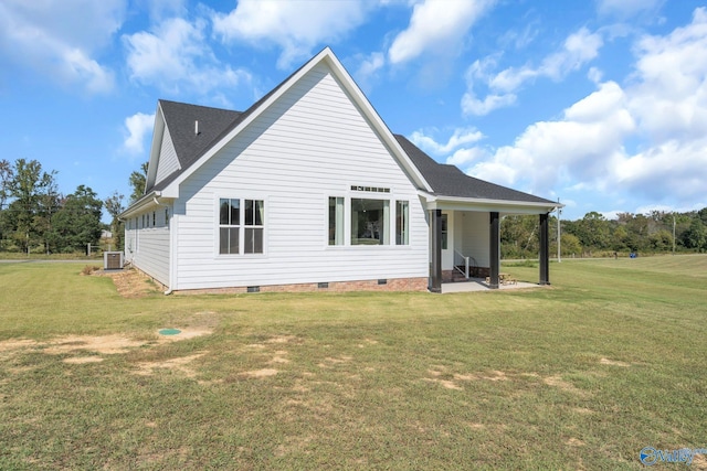 back of house with cooling unit, a yard, and a patio