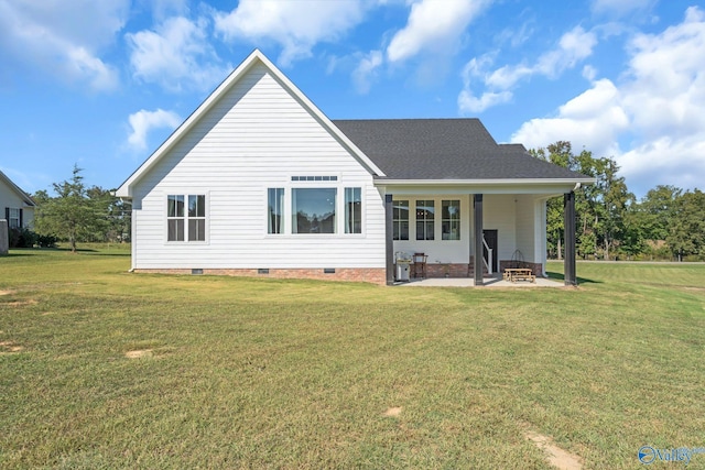 rear view of house with a lawn and a patio area