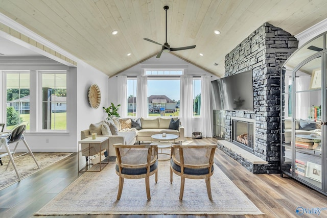 living room featuring wood-type flooring, a fireplace, vaulted ceiling, and wood ceiling