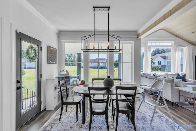 dining room featuring a notable chandelier, crown molding, and wood-type flooring