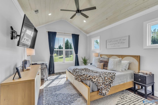 bedroom featuring ceiling fan, hardwood / wood-style flooring, lofted ceiling, and multiple windows