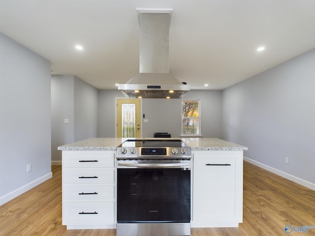 kitchen featuring white cabinetry, light wood-type flooring, island exhaust hood, and electric stove