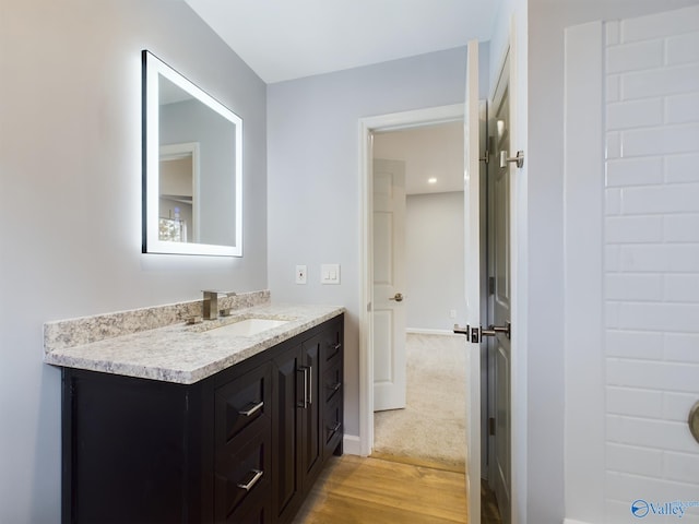 bathroom featuring vanity and hardwood / wood-style floors