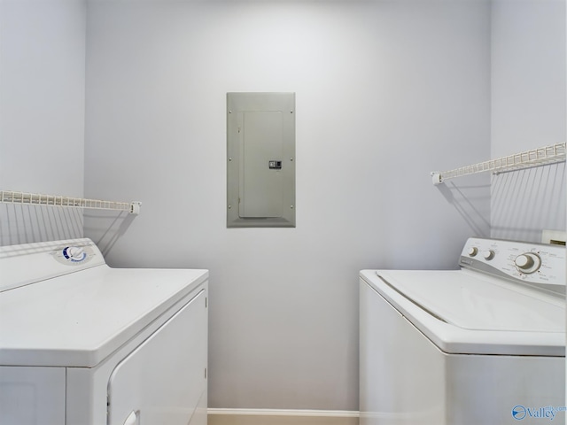 clothes washing area with electric panel and washing machine and dryer