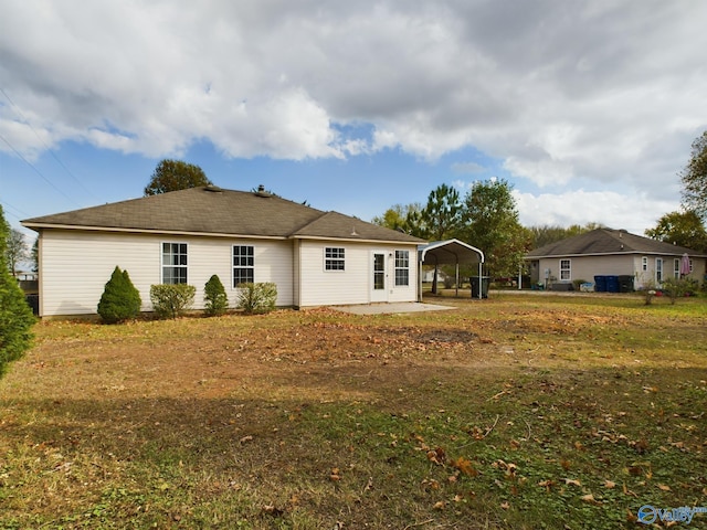 back of house featuring a carport