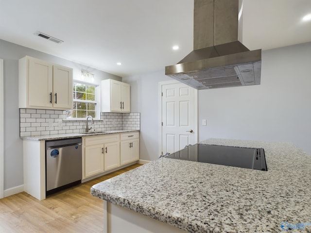 kitchen featuring light hardwood / wood-style floors, light stone counters, dishwasher, sink, and island exhaust hood