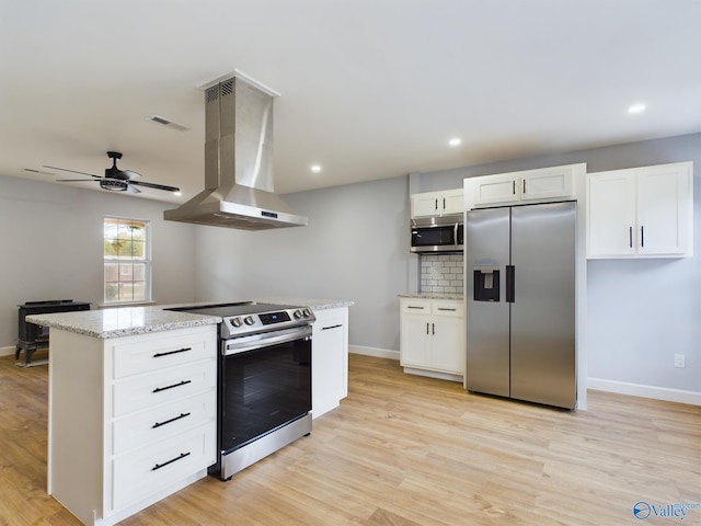 kitchen featuring stainless steel appliances, light stone counters, white cabinets, light hardwood / wood-style flooring, and range hood