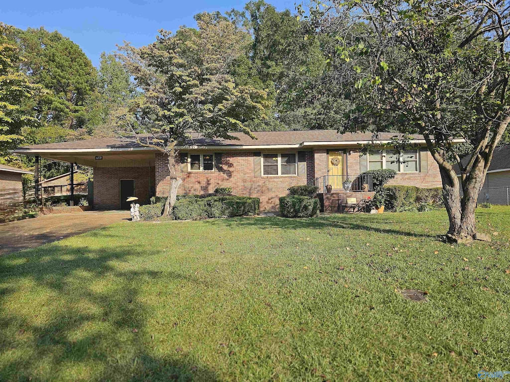 ranch-style house with a front yard and a carport