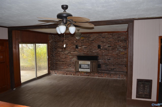 unfurnished living room featuring heating unit, a fireplace, wood finished floors, and ceiling fan